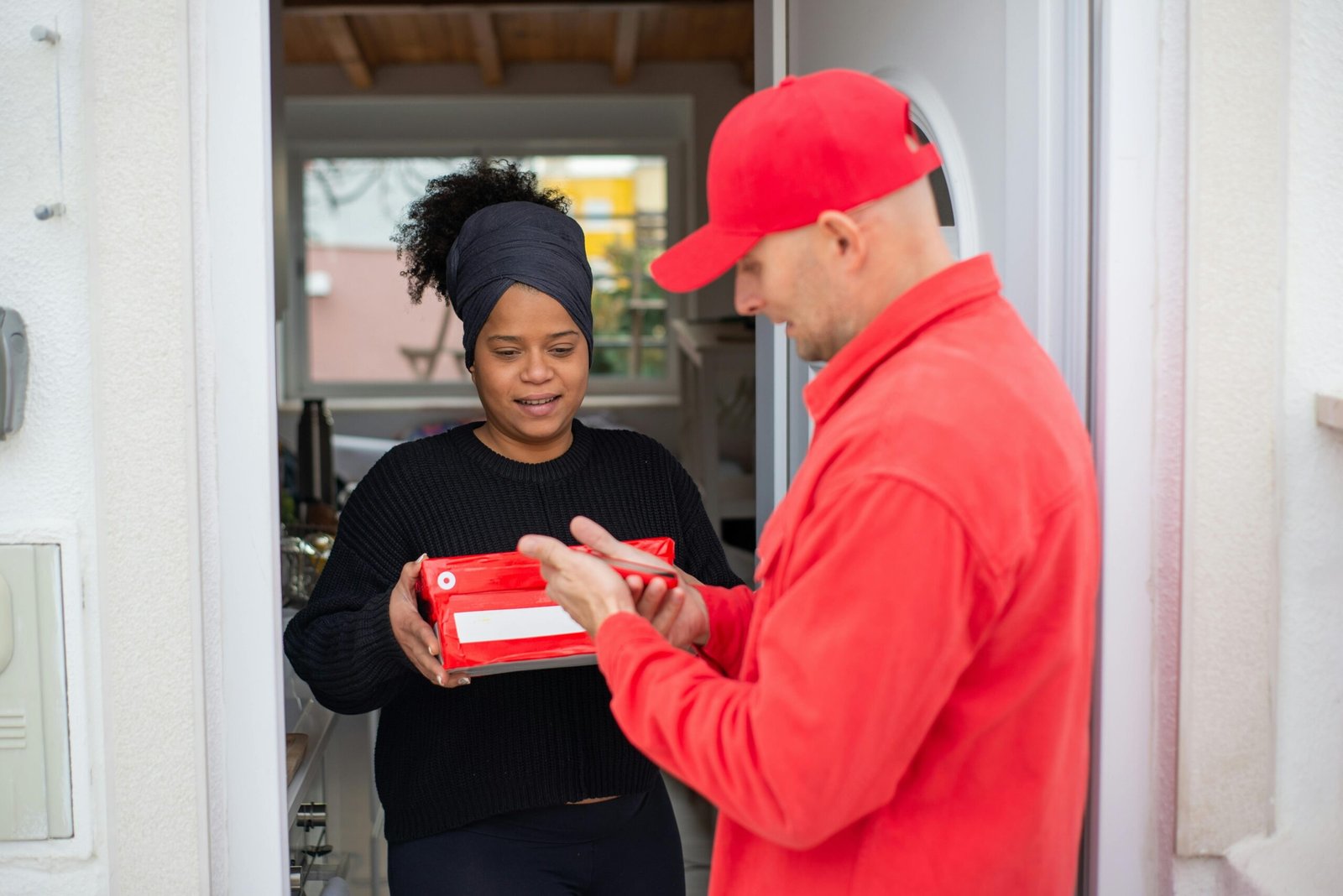 Delivery agent handing a package to a customer at the doorstep, ensuring safe and quick last-mile delivery service
